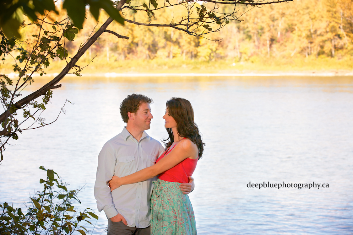 Photo of Couple by the River In Their Edmonton River Valley Engagement Pictures