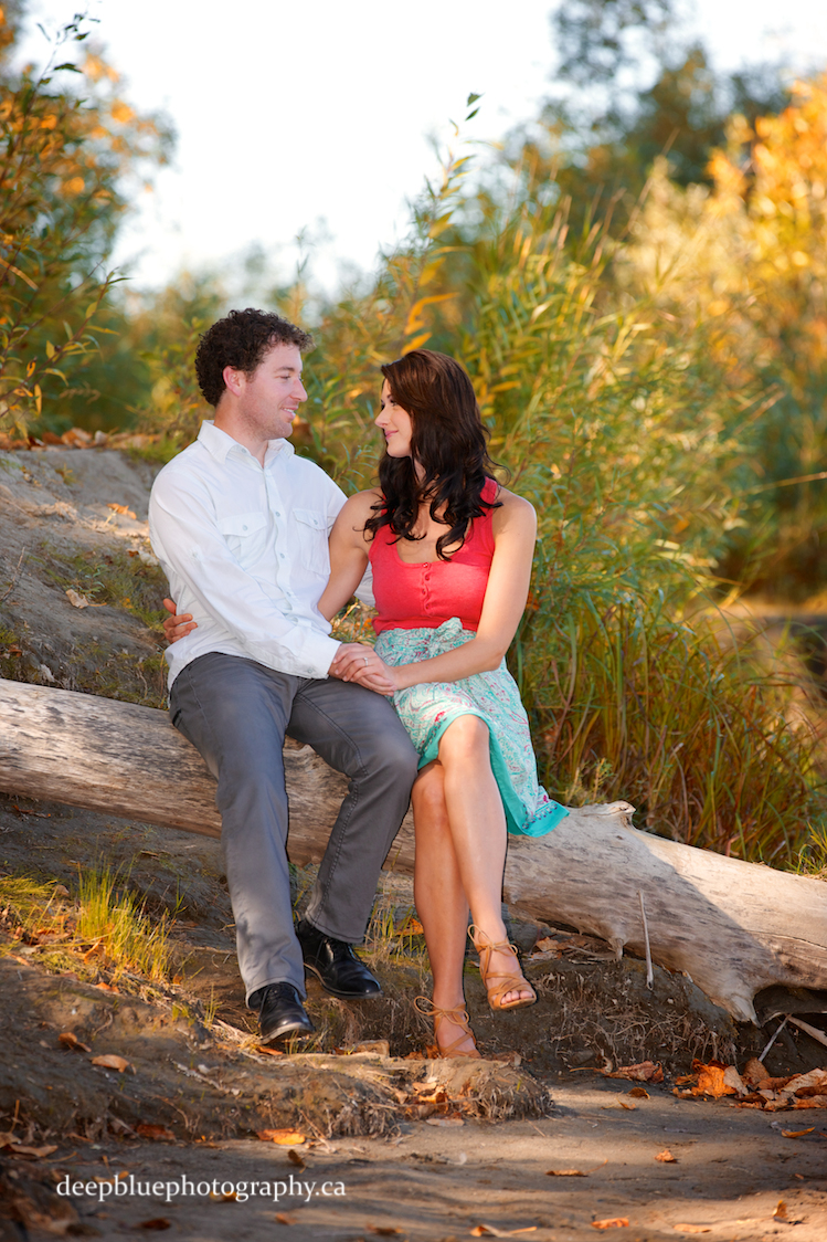 Photo of Couple Sitting on a Log - Edmonton River Valley Engagement Pictures
