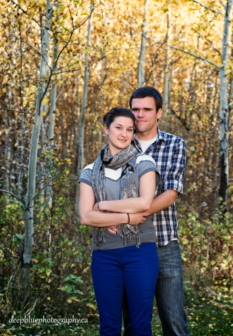 Chris with his arms around Natalie during their Blackfoot Trails Engagement Pictures.
