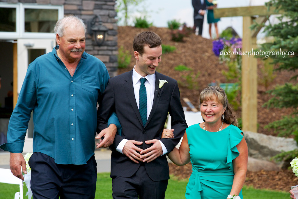 Photo of Groom Walked Down Aisle By Parents At A Countryside Golf And Country Club Wedding