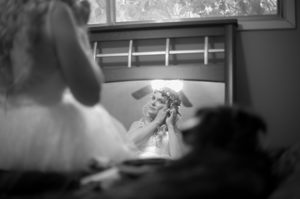 Photo of Bride Putting on Earrings