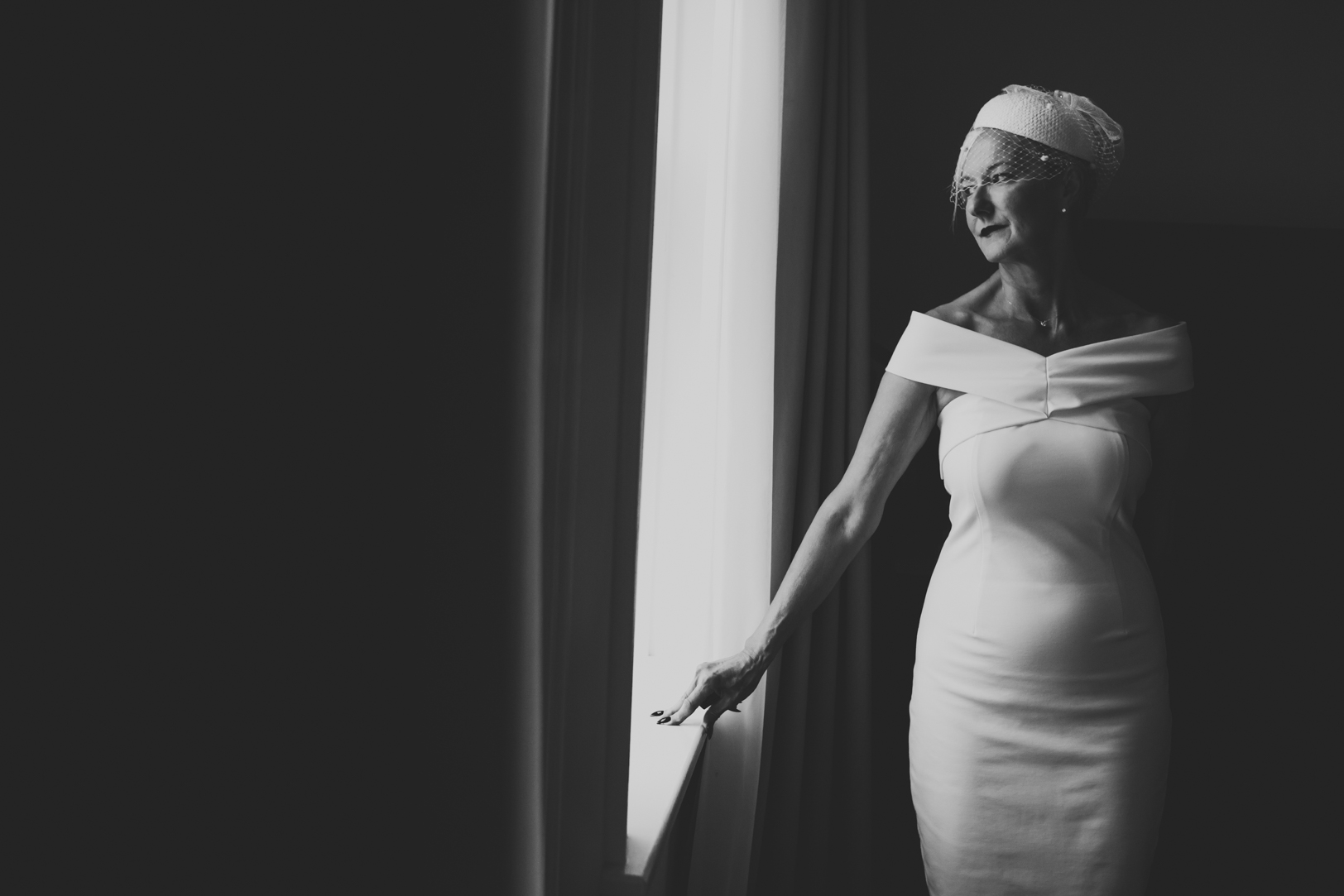 Bride posing by window - Fairmont Hotel MacDonald Wedding.