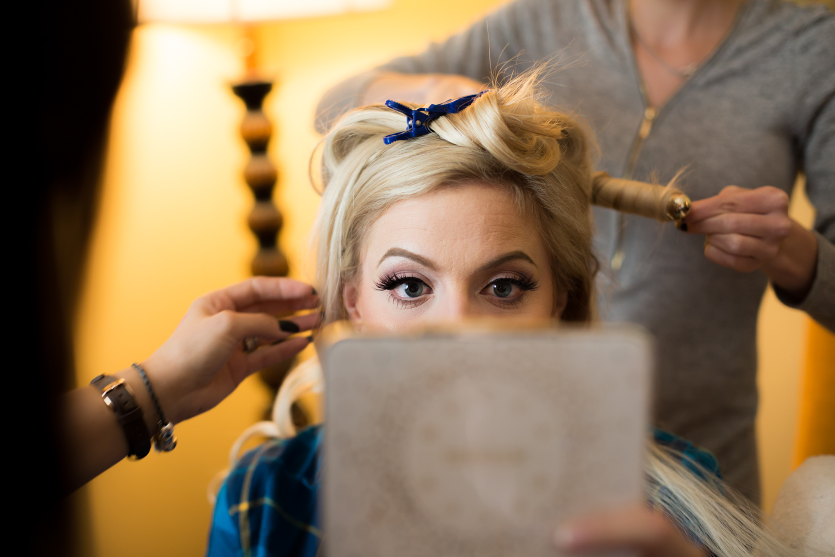 photo of bride getting hair and makeup done