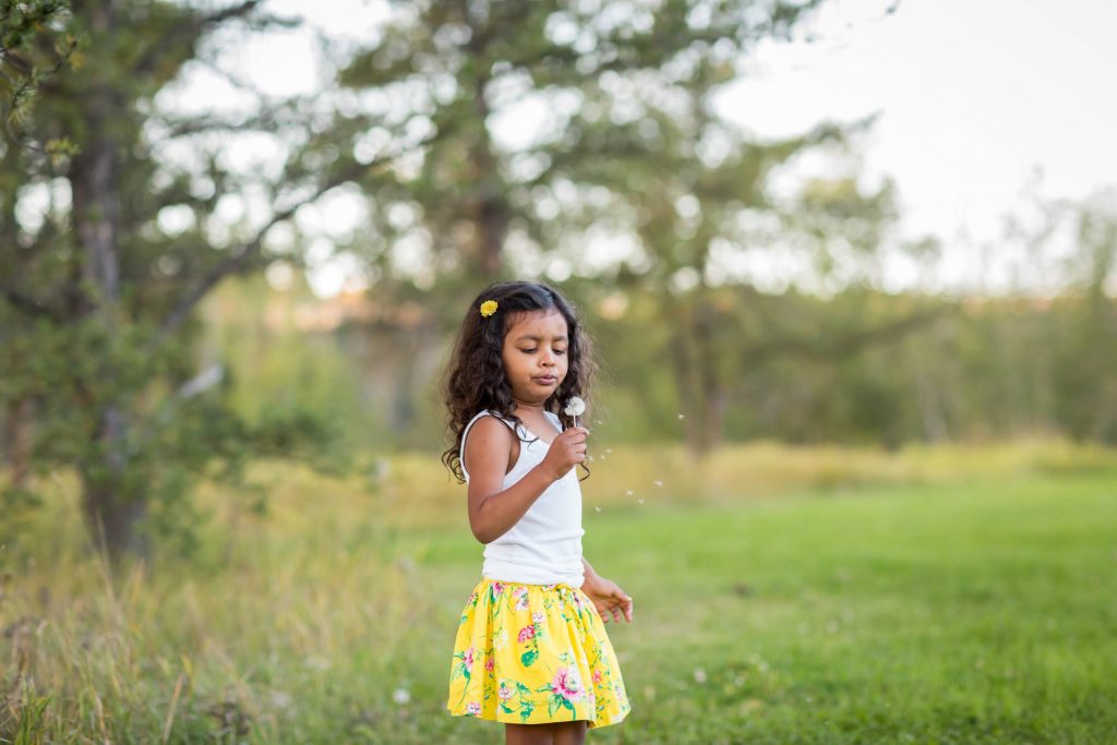Picture of young girl with dandelion
