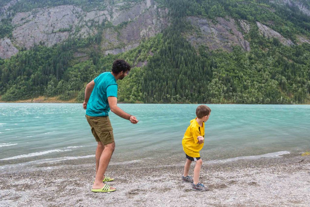 skipping rocks on a lake in the mountains