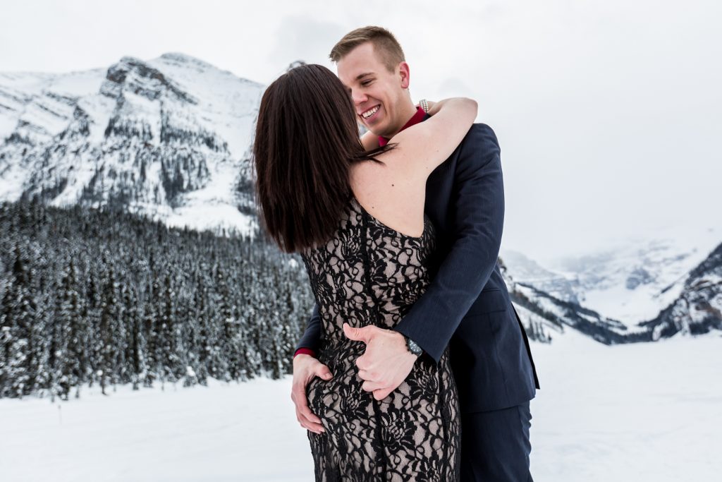 Couple holding each other close for winter engagement session - Mountain Engagement Photography by Deep Blue Photography