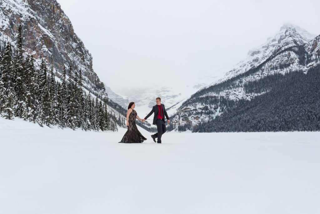 Couple walking and holding hands - Mountain Engagement Photography by Deep Blue Photography