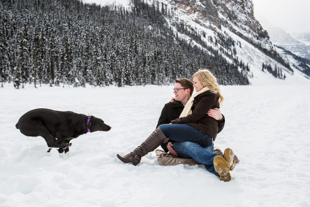 dog running towards owners during engagement session