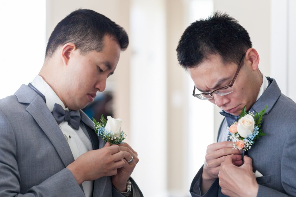 Groomsmen with ivory and blush rose boutonnieres 