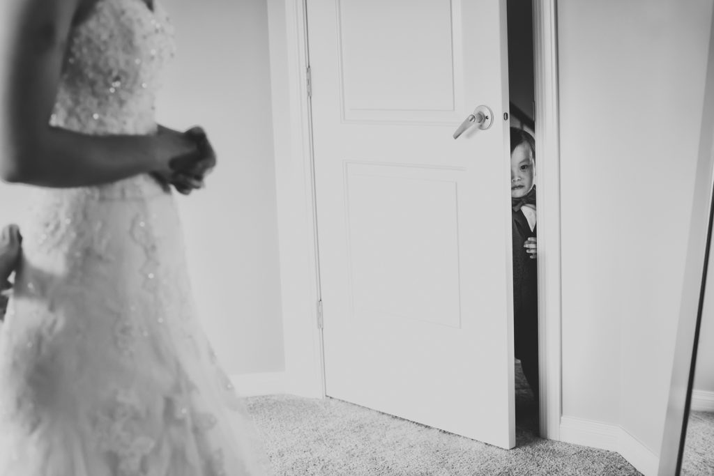 Ring bearer sneaking into the brides room while she is getting ready