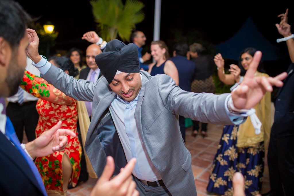 Guests dancing during Indian wedding reception at St James Club in Antigua