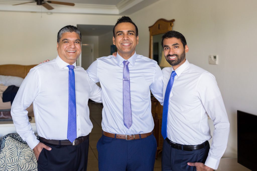 Formal portrait of the groom and his two best men before heading to the outdoor destination wedding ceremony
