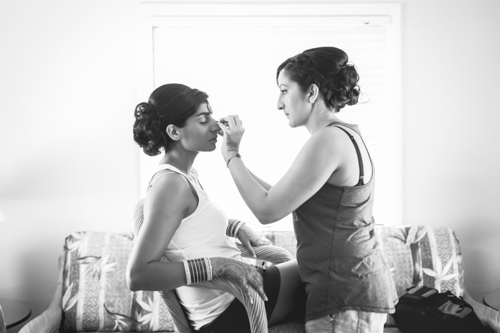 Makeup applies the finishing touches to this beautiful Indian bride before the wedding ceremony in Antigua