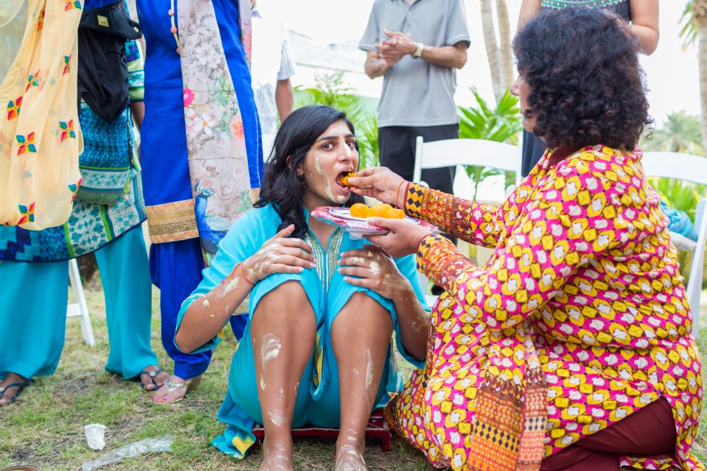 Mother of the bride feeding her daughter during destination wedding Mayian ceremony in Antigua
