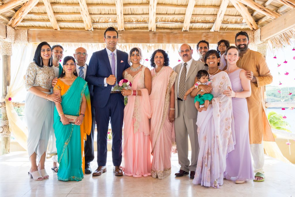 Destination wedding family portrait which includes both the bride and grooms entire immediate family