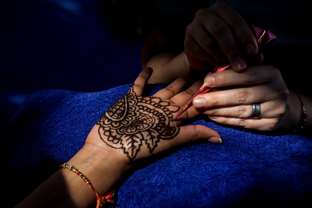 Traditional bridal mendhi being done for the bride during Antigua destination wedding preparations