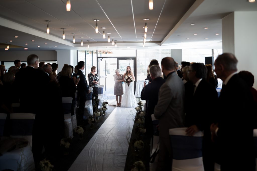 Bride entering the Riverview room for Shaw Conference Centre wedding ceremony