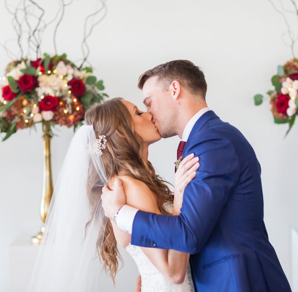 Bride and groom first kiss during their Shaw Conference Centre wedding