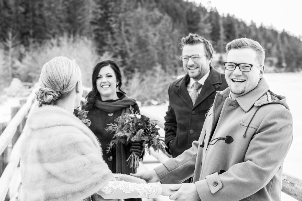 Candid photo of the wedding party greeting the bride and groom after their first look on the bridge to Pyramid Lake island