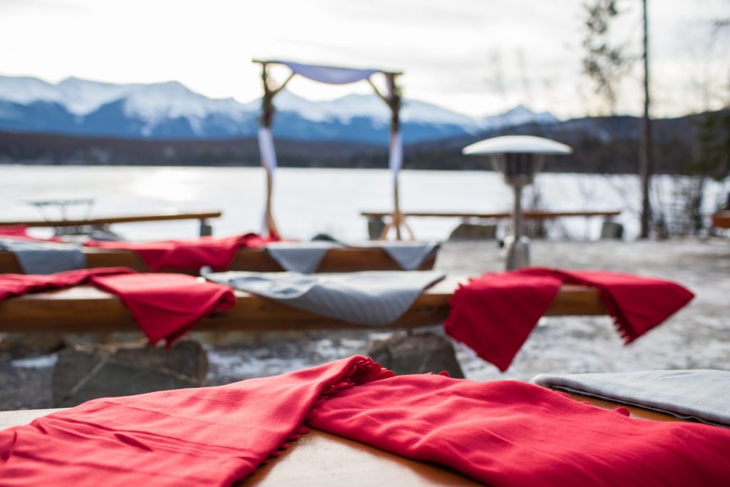 Blankets were set out on the benches for guests during this outdoor winter wedding at Pyramid Lake island