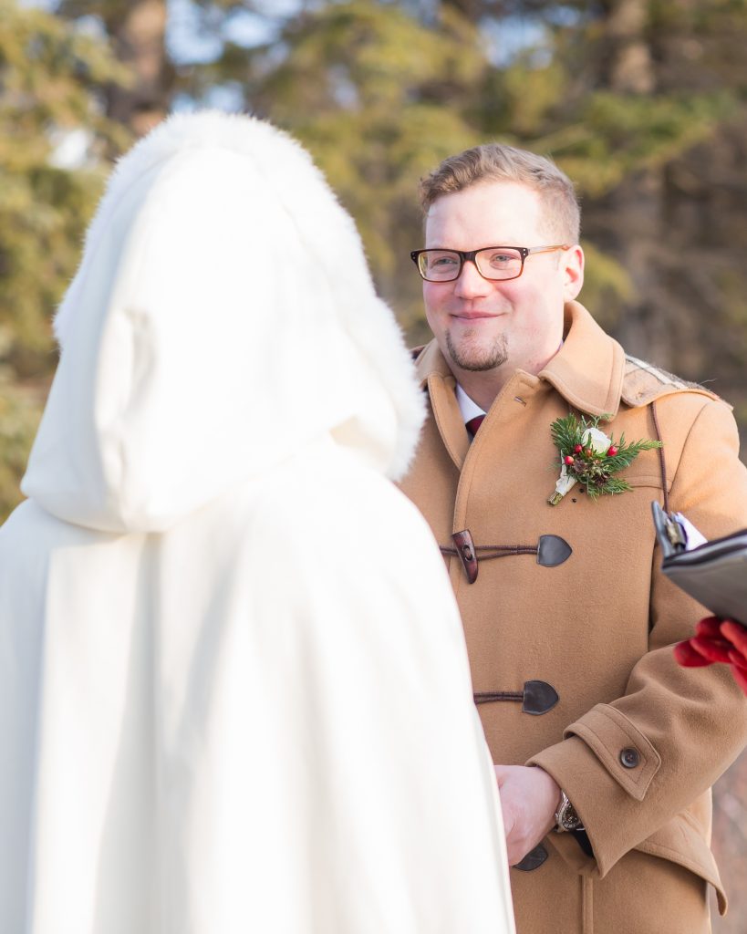 Groom during outdoor wedding ceremony at Pyramid Lake in the winter