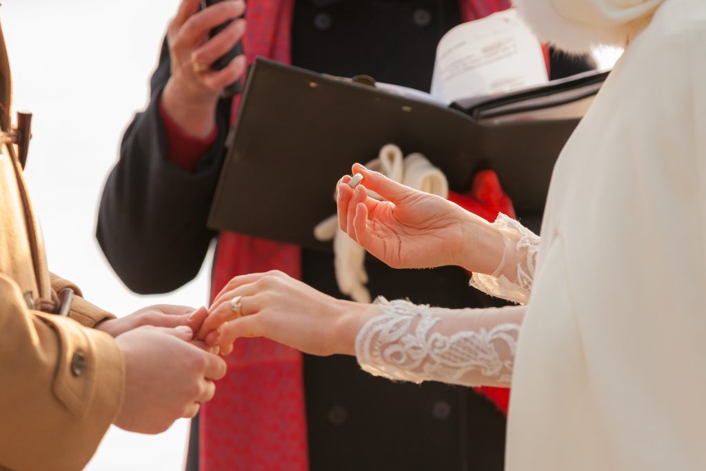 Ring exchange on Pyramid Lake Island during wedding ceremony