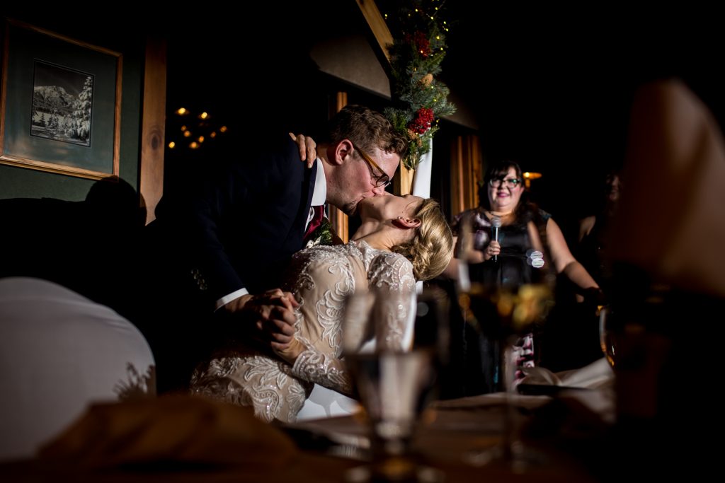 Bride and groom participate in the kissing game during their reception at Pyramid Lake