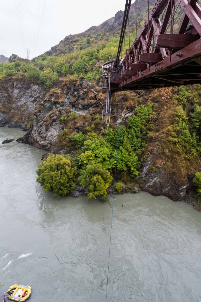Bungy jumper mid-flight off the Kawarau Gorge Suspension Bridge