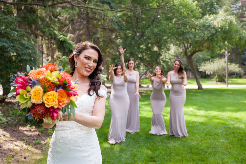 Bridesmaids catching bouquet
