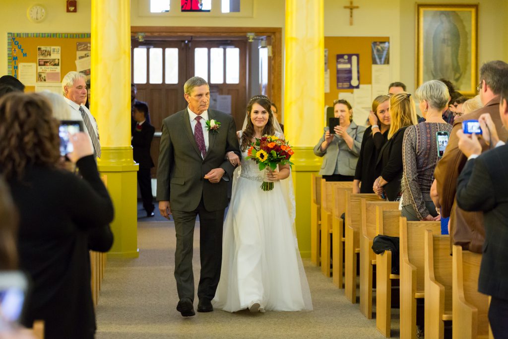 bride walking down aisle with father