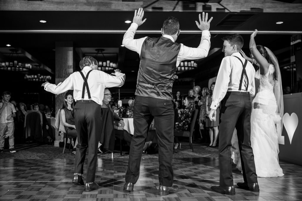 father and sons dancing together