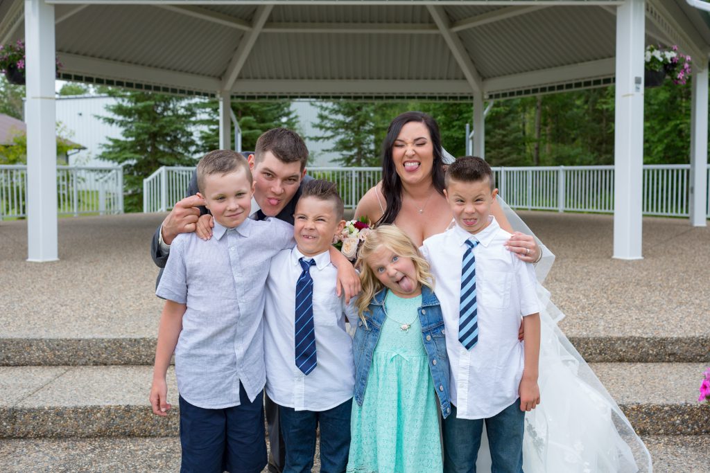 Bride and Groom photo with wedding party kids